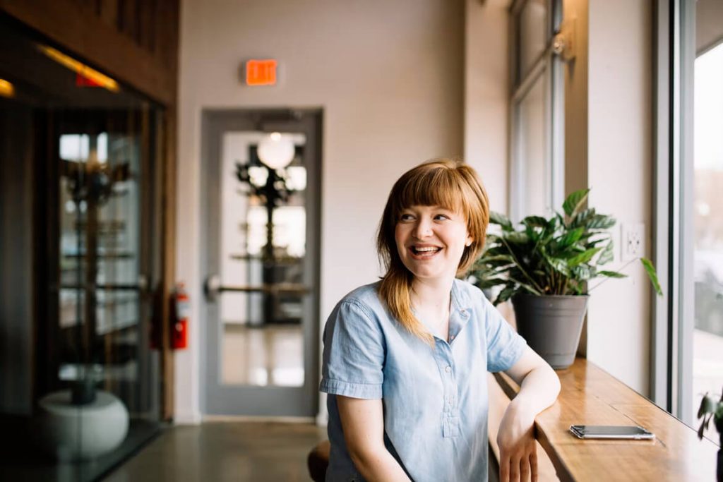 woman sitting in work area by window